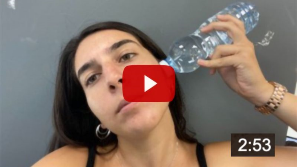 video preview of woman inserting water in ear