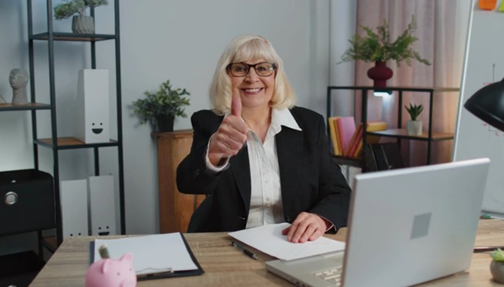 woman in office thumbs up
